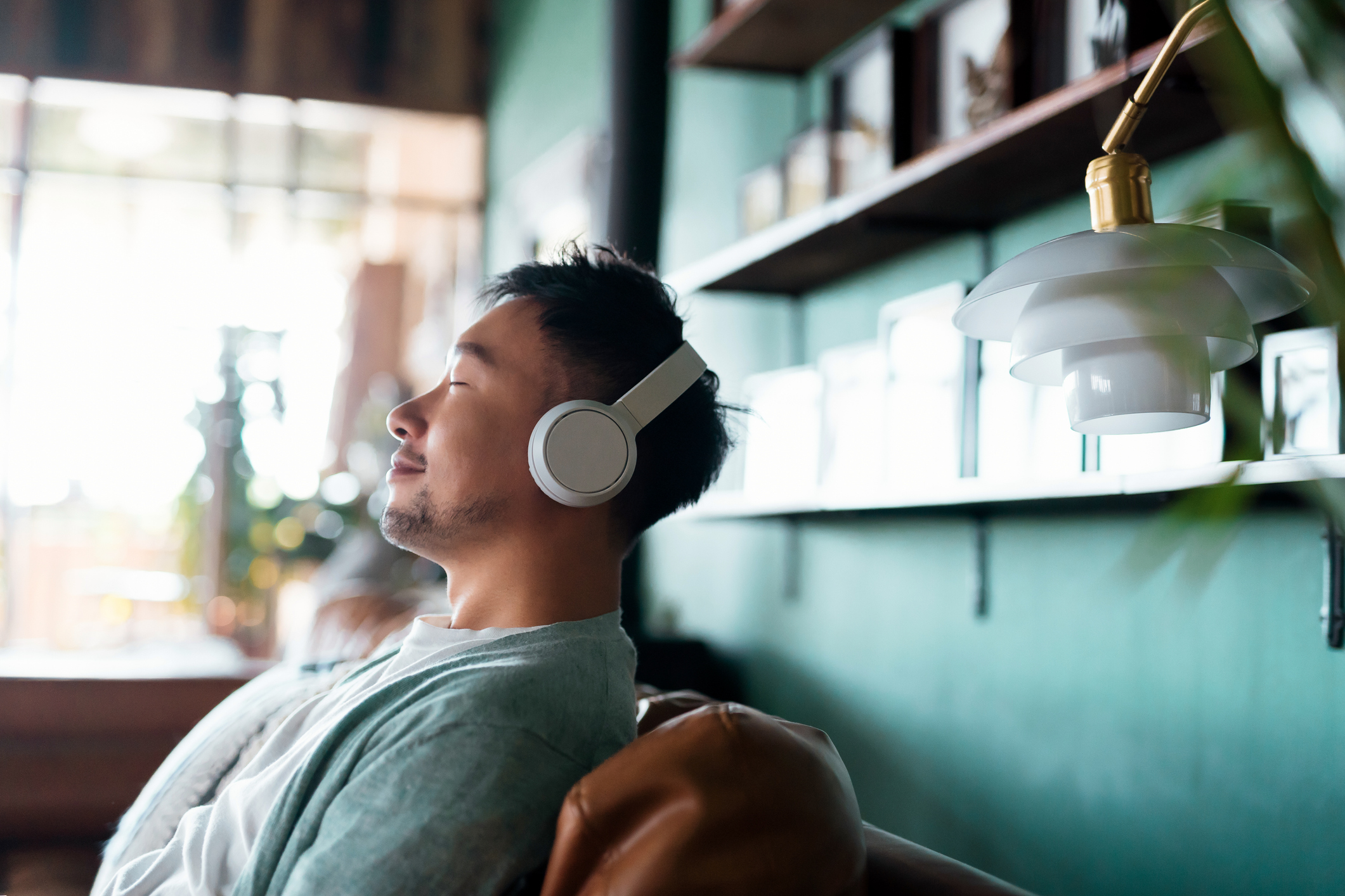Young man with eyes closed, relaxing with headphones