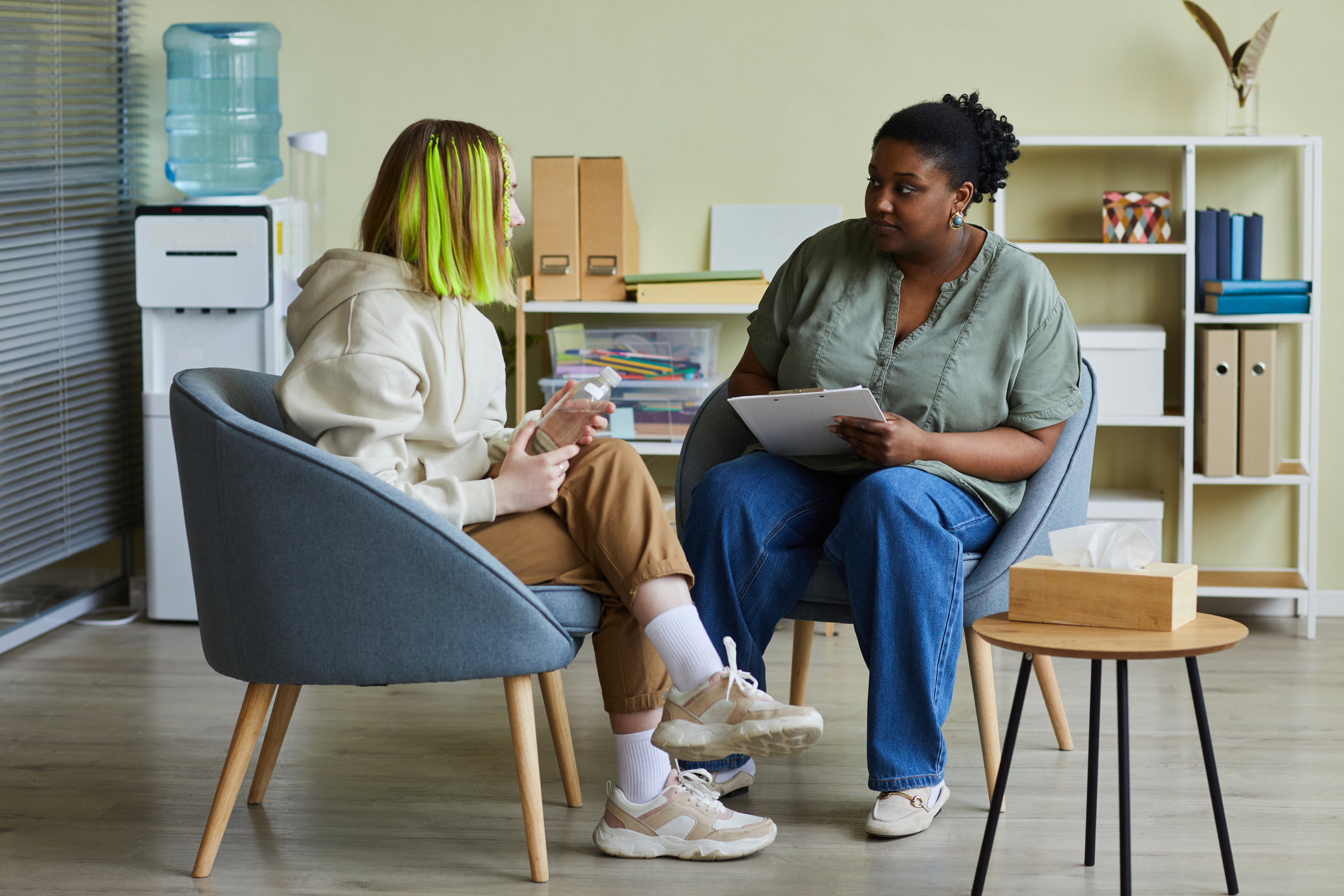 Woman talking to teenage girl