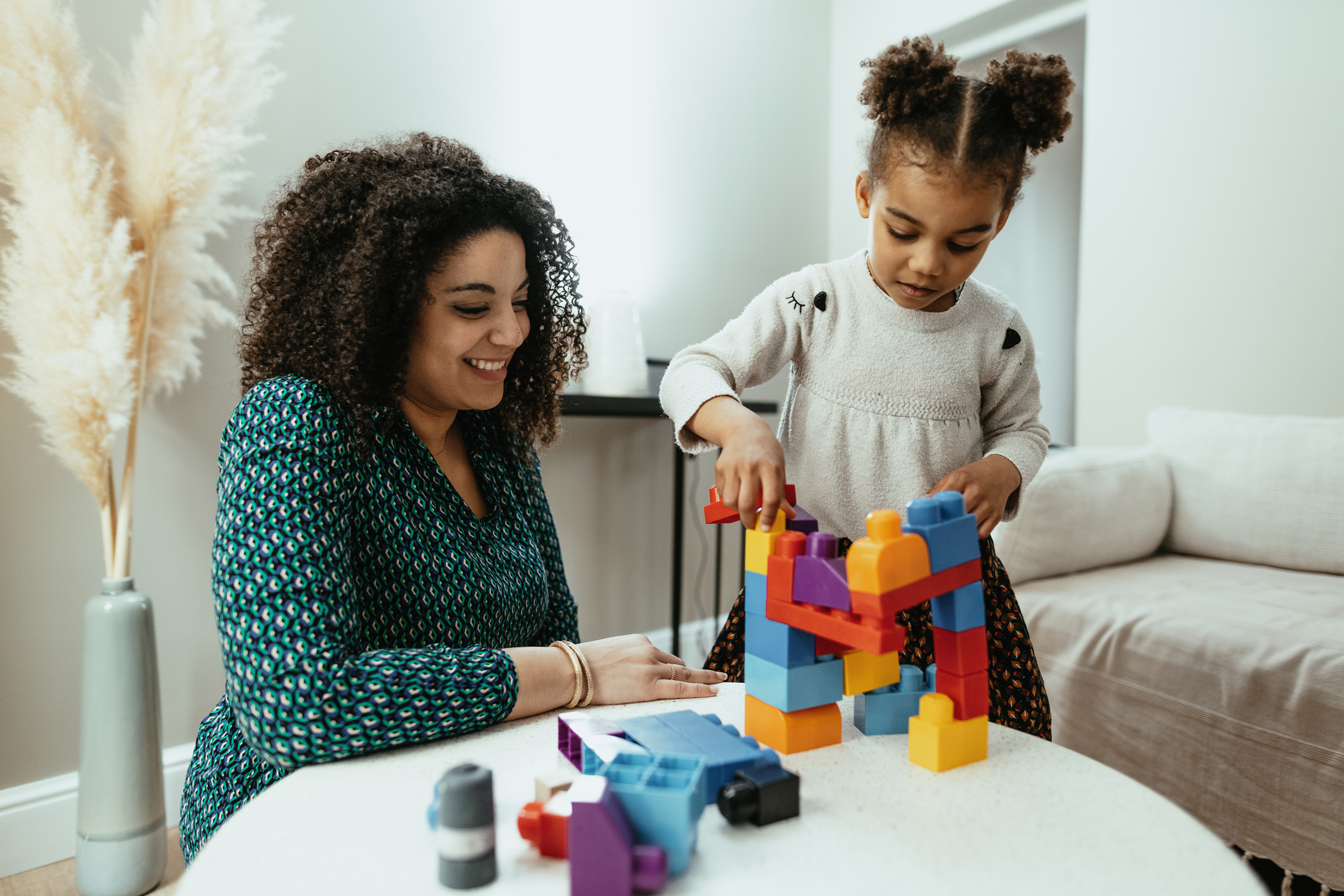 Mother and daughter playing with toy blocks